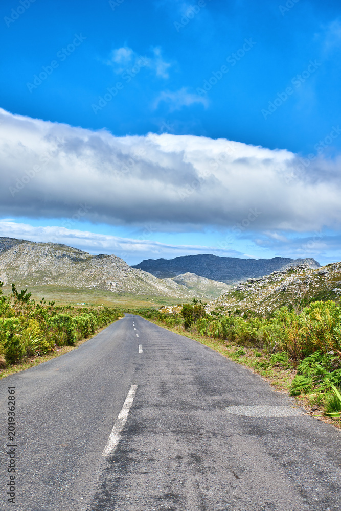 Naklejka premium Travel, empty and road with landscape for adventure, tourism destination and location in valley. Background, space and street with nature, plants and outdoor for journey, trip and route on mountain