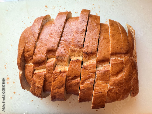 freshly baked loaf of artisan bread cut into thick slices