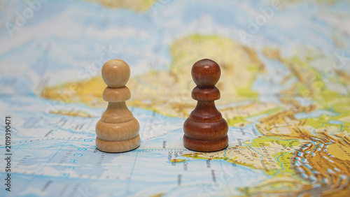 Chess pieces on a map showing different countries near bodies of water and land masses