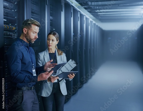 IT professionals discussing server security in data center