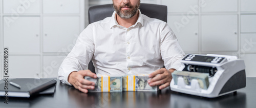 Bank operation, loan. Business solution. Businessman working in exchange office. Money counter. Money counting machine. Economic wealth and value investing