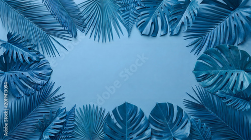 Monochromatic blue tropical leaves frame on solid background