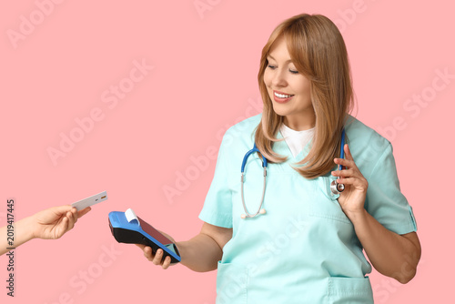 Female doctor receiving pay...
