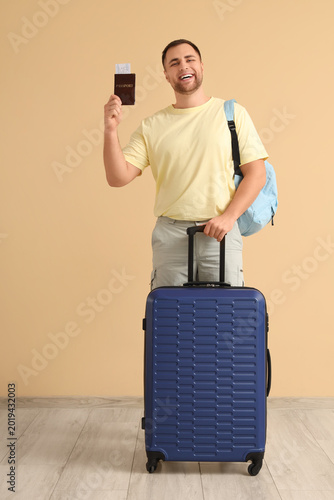 Young man with suitcase and...