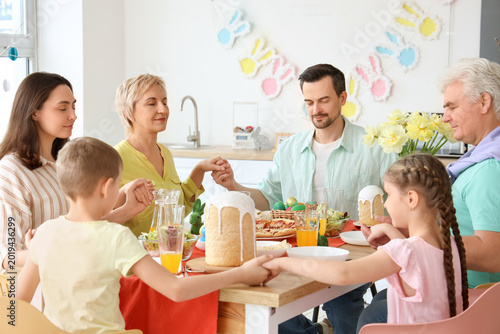 Big family praying before E...