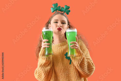Young woman with beer blowi...