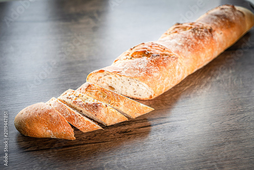 Photography still life with French fresh bread baguettes with poolish on a wooden cutting bo