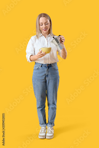 Pretty young woman pouring ...