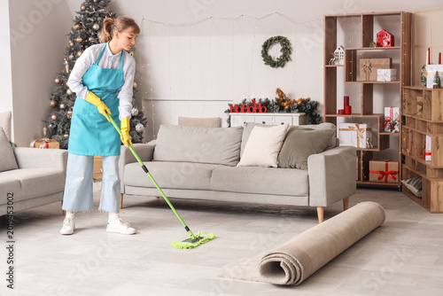 Young janitor mopping floor...