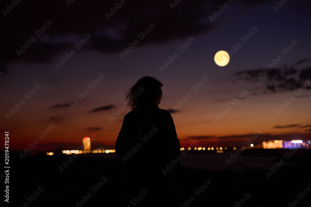 Fototapeta premium Woman observing stars, planets, Moon and other celestial objects.