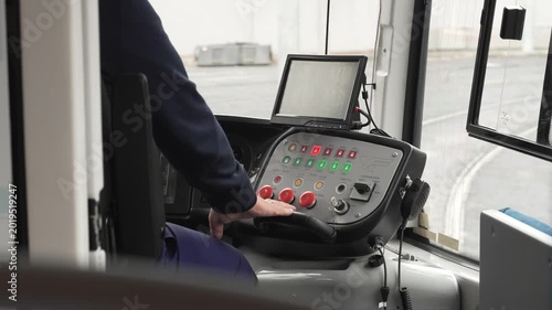Tram driver's job. The driver controls the car's movement using a dashboard with display and buttons.