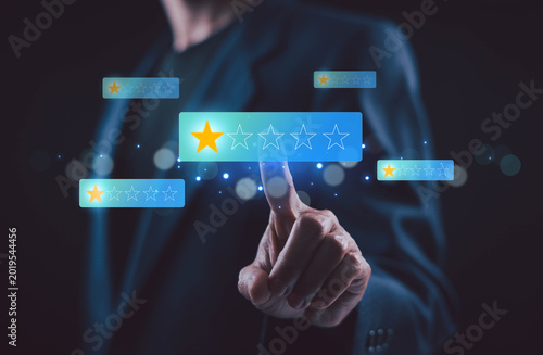 Customer feedback and satisfaction concept with low one star rating on virtual screen, business person touching digital review interface for poor service, evaluation, complaint and user experience.