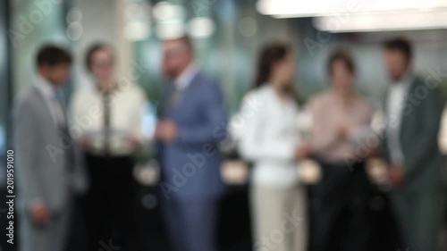 Blurred group of professionals in a modern office setting