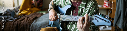 Foto Header of young adult musician playing electric guitar at home, practicing chords and songwriting for creative hobby and music education