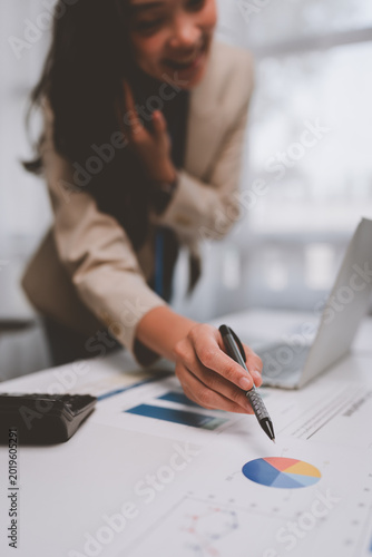 Businesswoman analyzing financial data on office documents