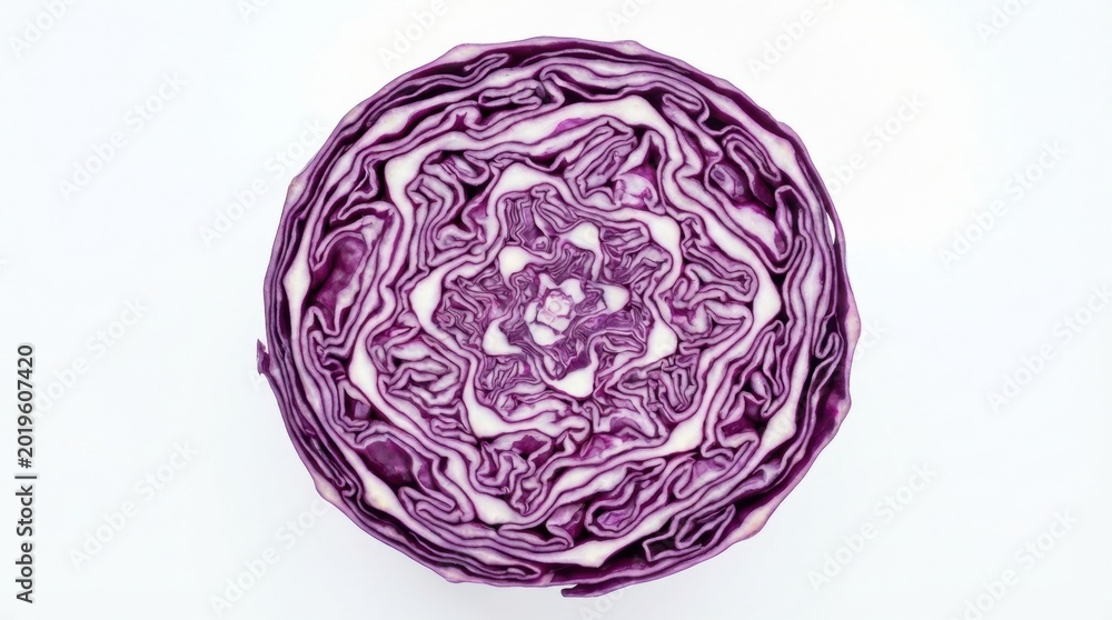 Fototapeta premium Close-up top view of a halved vibrant red cabbage on a white surface.