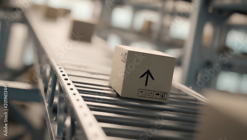 Cardboard box with shipping symbols moves along an industrial conveyor belt
