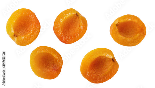 Schilderij op canvas Five halved ripe apricots showing juicy flesh, isolated on transparent backgroun