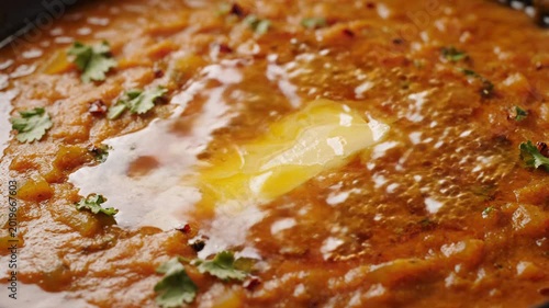 Warm spicy pav bhaji with melting butter on top, a macro close-up of popular indian street food.