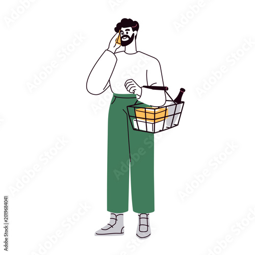 Man holding grocery store basket with purchases, speaking on mobile phone. Su...