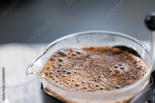Macro closeup of coffee crema bubbles and texture on french press surface