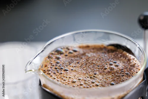 Fototapeta Macro closeup of coffee crema bubbles and texture on french press surface