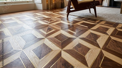 Intricate geometric wooden floor pattern featuring contrasting dark and light wood panels inlaid with thin brass strips creating a luxurious and modern aesthetic within a stylish home interior on tran