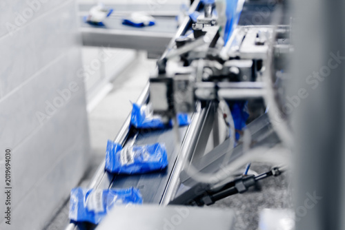 Obraz na plátně Milk food industry, Conveyor line transporting blue packaged products through pr