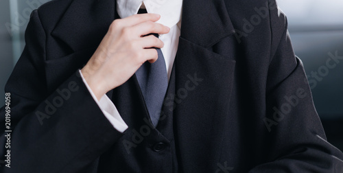 Businesswoman adjusting tie closeup for corporate portrait and professional presentation banner background