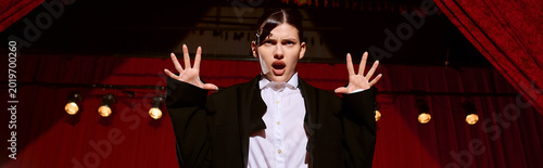 Canvas Print A young woman expresses artistry and emotion on stage in a vibrant theater