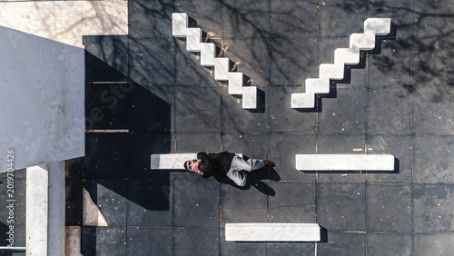 Concept of wireless technology. Top View of A man lying down using a smartphone.