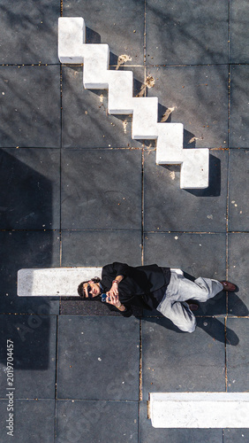 Concept of wireless technology. Top View of A man lying down using a smartphone.