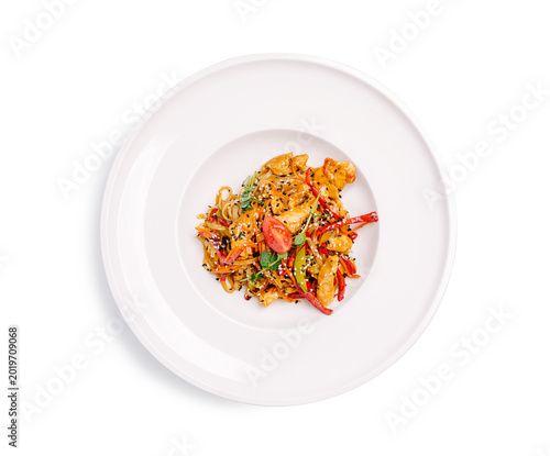 Chicken stir fry with mixed vegetables served on a white plate