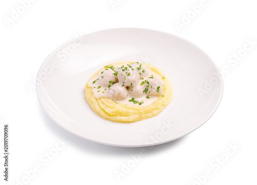 A serving of mashed potatoes is placed in a round bowl