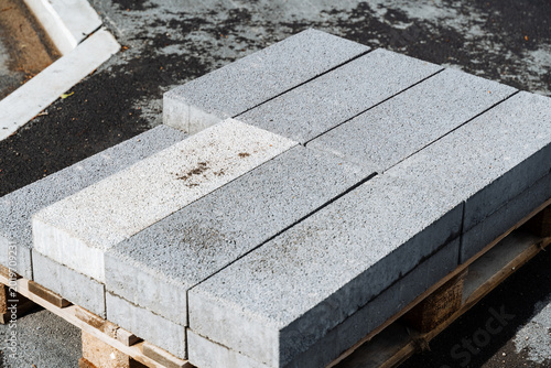 Картината върху платно Heavyduty granite curbstone sections prepared for landscape work