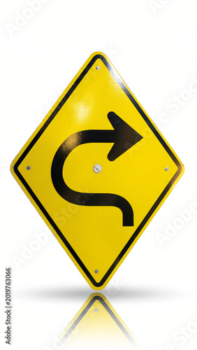 Yellow road sign indicating a sharp right turn.