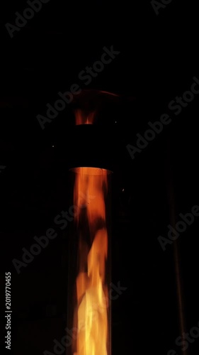 Slow Motion Fire Burning Inside a Vertical Glass Tube in Dark Environment Cinematic Footage