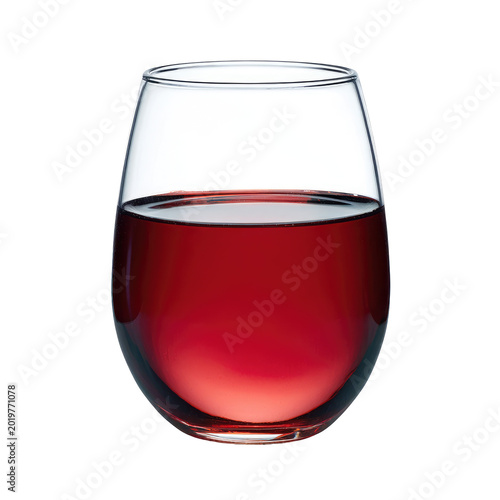 Stemless glass filled with a red liquid, likely wine. The glass reflects light and the background is black, emphasizing the liquid