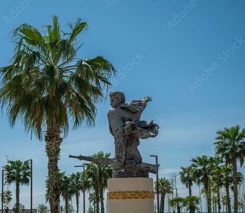 Photos World War II partisan monument with armed figure in Durres