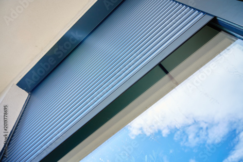 Obraz na plátně Exterior roller shutter partially open on modern window