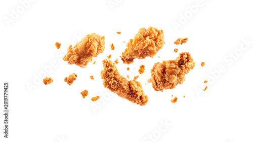 Fried chicken wings flying through air with crumbs