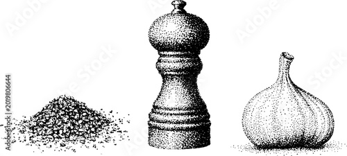 Pepper grinder between coarse spice pile and garlic bulb on white