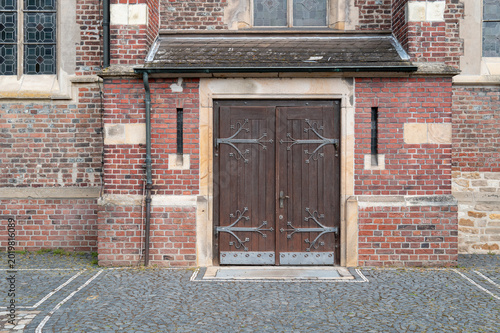 Old church wooden door with ornate metal hinges