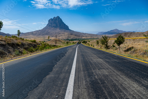 Huge monolith stands along a road in Nakhchivan, showcasing natural beauty and cultural significance in Azerbaijan landscape