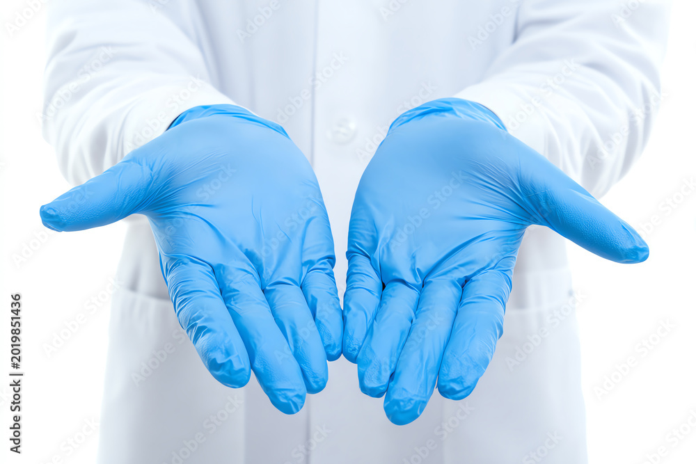 Fototapeta premium A medical professional in blue gloves holds out their hands, symbolizing safety and hygiene in healthcare practices.