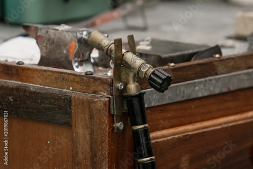 Quadro em tela Close up of a vintage blow torch and anvil in a workshop setting