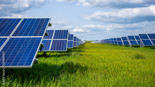 Εκτύπωση καμβά Rows of solar panels in a green field generating clean renewable energy under a