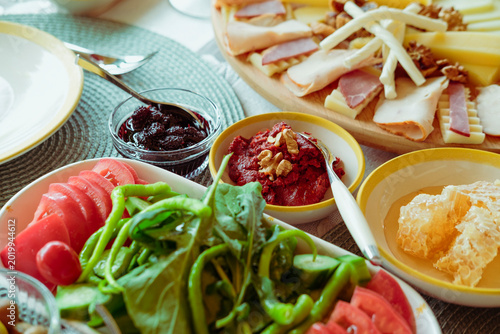cheese plate, variety, sliced served for breakfast, branch with honey