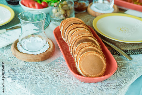 pancakes spong soft served with turkish tea glass for breakfast or branch, summer outdoors lifestyle