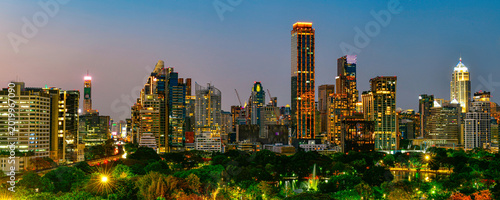 Beautiful twilight cityscape of Bangkok financial district and Lumphini Park, seen from Dusit Central Park.